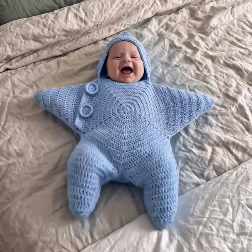 Baby wearing a blue star-shaped hooded outfit